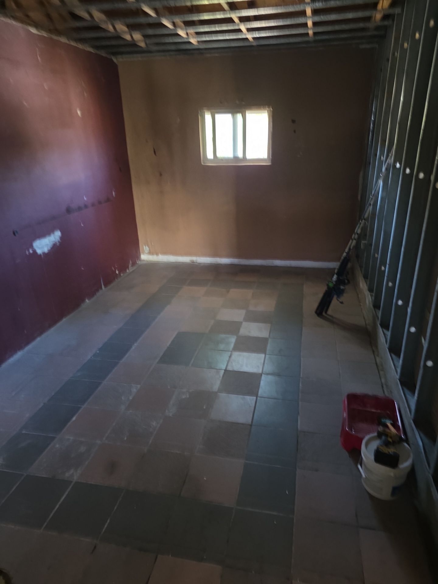 Room stripped to bare walls and open ceiling framing after fire damage